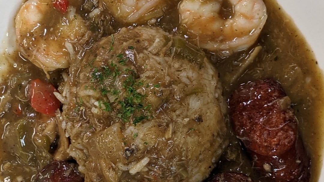 A bowl of gumbo with shrimp, andouille sausage and a scoop of rice at Stinkin' Crawfish
